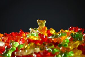 A gummy bear atop a pile of fallen gummy bears. He is obviously the winner and survivor of the gummypocalypse. Your Writing Sucks? Nope. Like you, this gummy bear is triumphant.