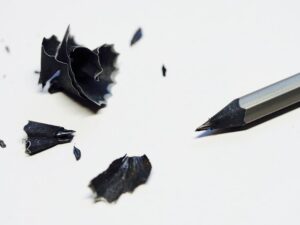 An unusual pencil made of black wood with black pencil shavings. How to Become a Better Writer